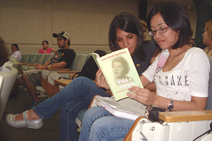 Two students who participated in the event check out the book.