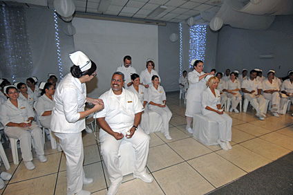 Los graduandos recibieron los símbolos de la profesión, una cofia adornada con cintas verde y negro, para las féminas, y para los varones, las mismas cintas alrededor del cuello.