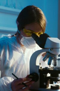 pexels-artempodrez-5726706 image of person looking into a microscope