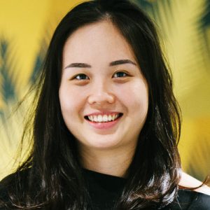 Stock photo of a young person with black hair smiling. 