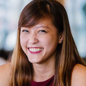 Stock photo of a young person with long hair and smiling. 