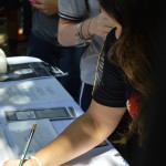 Students signing up at a promotion table for the Open House.