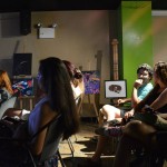 A picture of the audience who are listening to the artists presenting their works on the open mic nights. In the background there are several painted works on display. EDSA collaborated with TACU and La Cueva de Tarzan to host an ”Open Mic Night” as part of La Cueva de Tarzan’s 9th Anniversary Celebration.