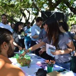 Students picking up information pamphlets at one of the multiple info tables for the different organization during the Open House.