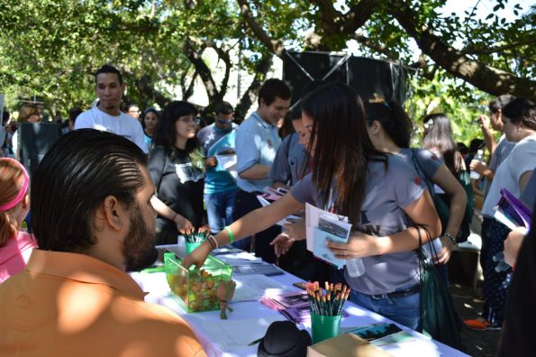 Students picking up information pamphlets at one of the multiple info tables for the different organization during the Open House.