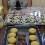 EDSA Book & Bake Sale table with cupcakes, muffins, cookies, napkins and cups.