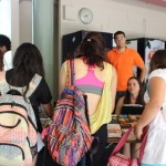 Students looking at the books on the second table of the EDSA Book & Bake Sale.