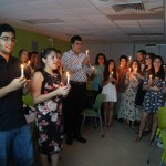 Students holding lit candles at the EDSA Fall Initiation of 2014.