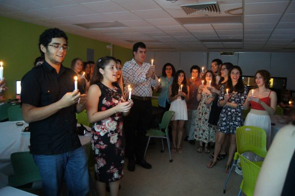 Students holding lit candles at the EDSA Fall Initiation of 2014.