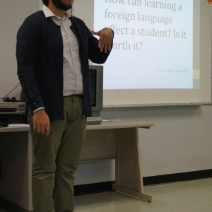 A student presenting material in front of the classroom at the Linguistics Colloquium 2015.