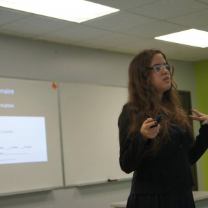 A student presenting material in front of the classroom at the Linguistics Colloquium 2015.