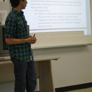 A student presenting material in front of the classroom at the Linguistics Colloquium 2015.