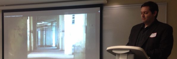 Cropped image of the podium and the screen where a material is being presented for the audience.