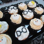 A tray of muffins with Harry Potter themed decorations on top.