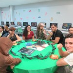 Students sitting on a table representing the Slytherin house from Happy Potter.