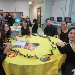 Students sitting on a table representing the Hufflepuff house from Happy Potter.