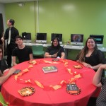 Students sitting on a table representing the Gryffindor house from Happy Potter.