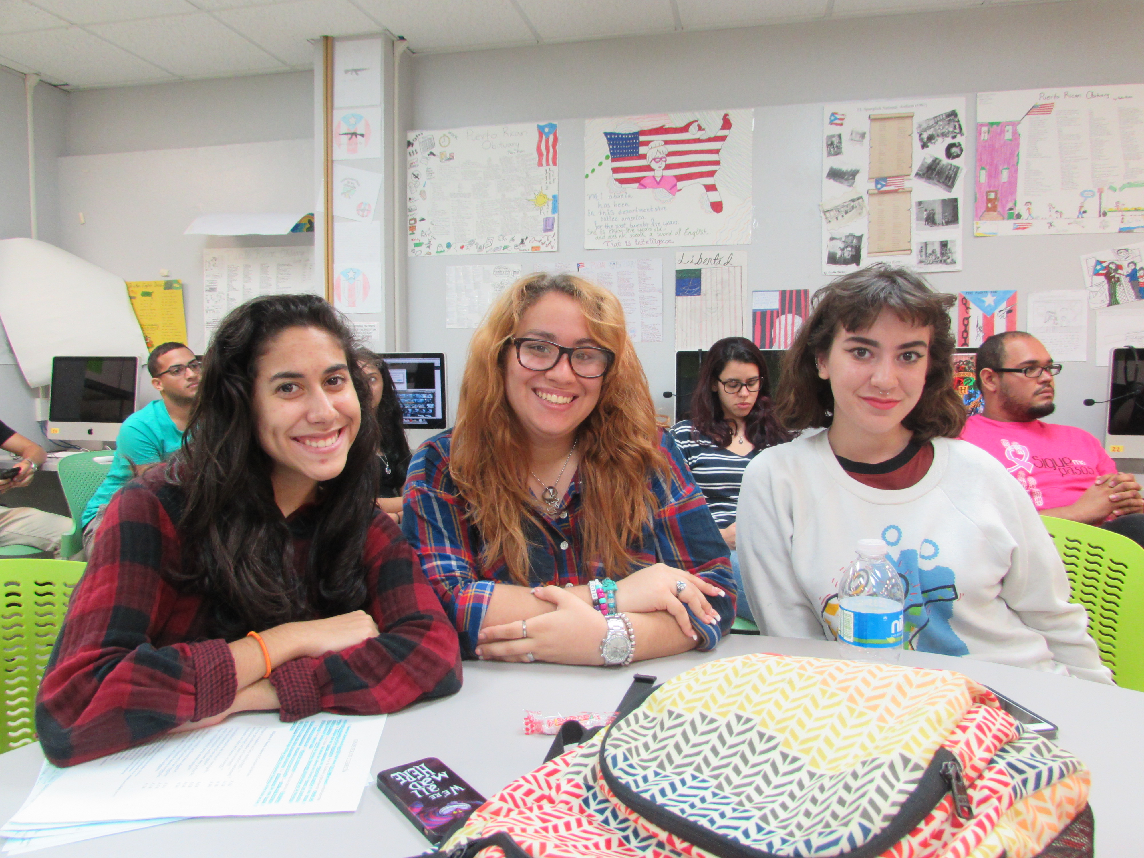 Three students posing for the camera who are attending the Undergraduate Mixer.