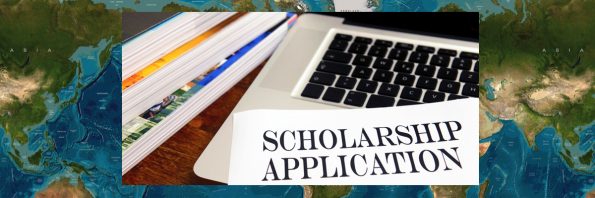 The words Scholarship Application are presented on top of a laptop next to some books.