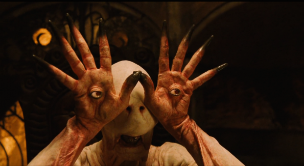 A pale skinned humanoid monster with his eyeballs in the palms of his hands from the movie Pan's Labyrinth.