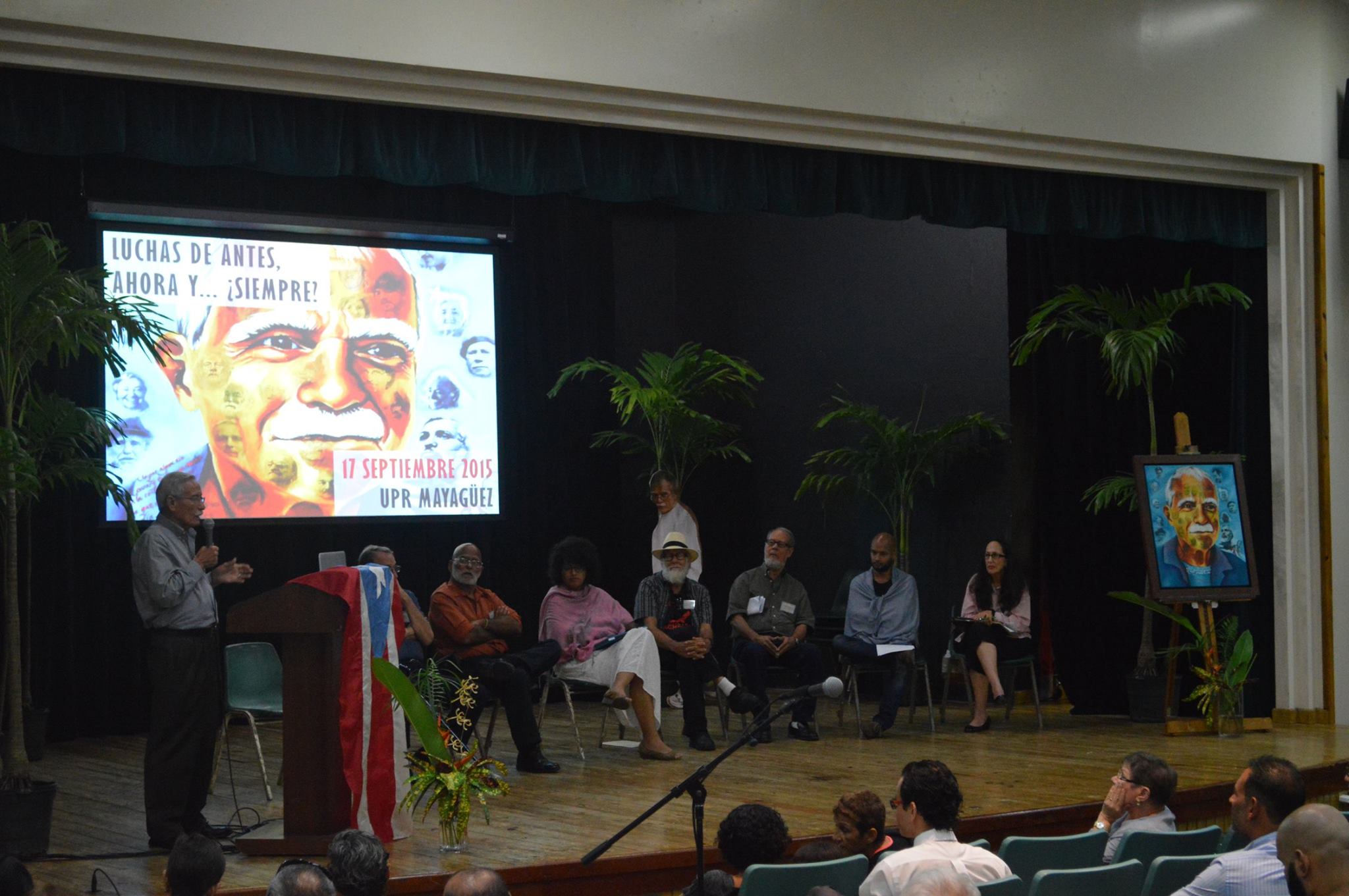 A panel of speakers is sitting on the stage answering questions from the audience.