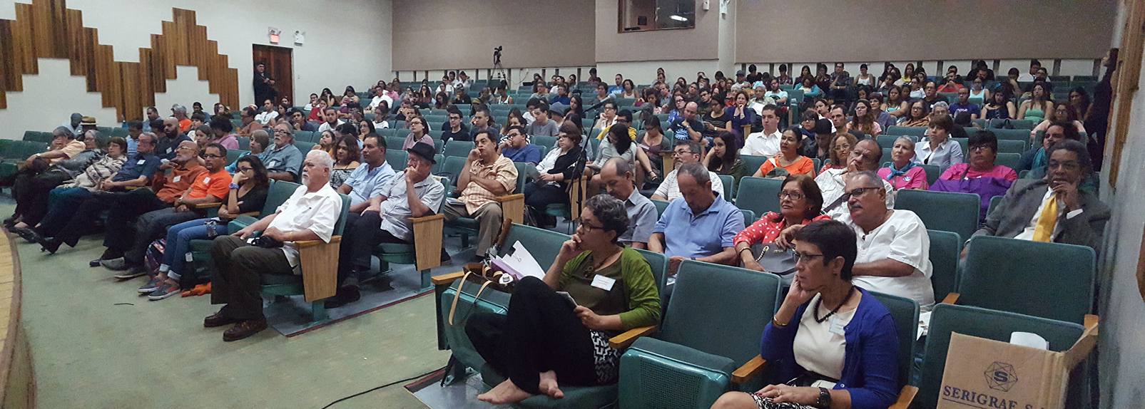 The audience paying close attention to the panel of speakers.