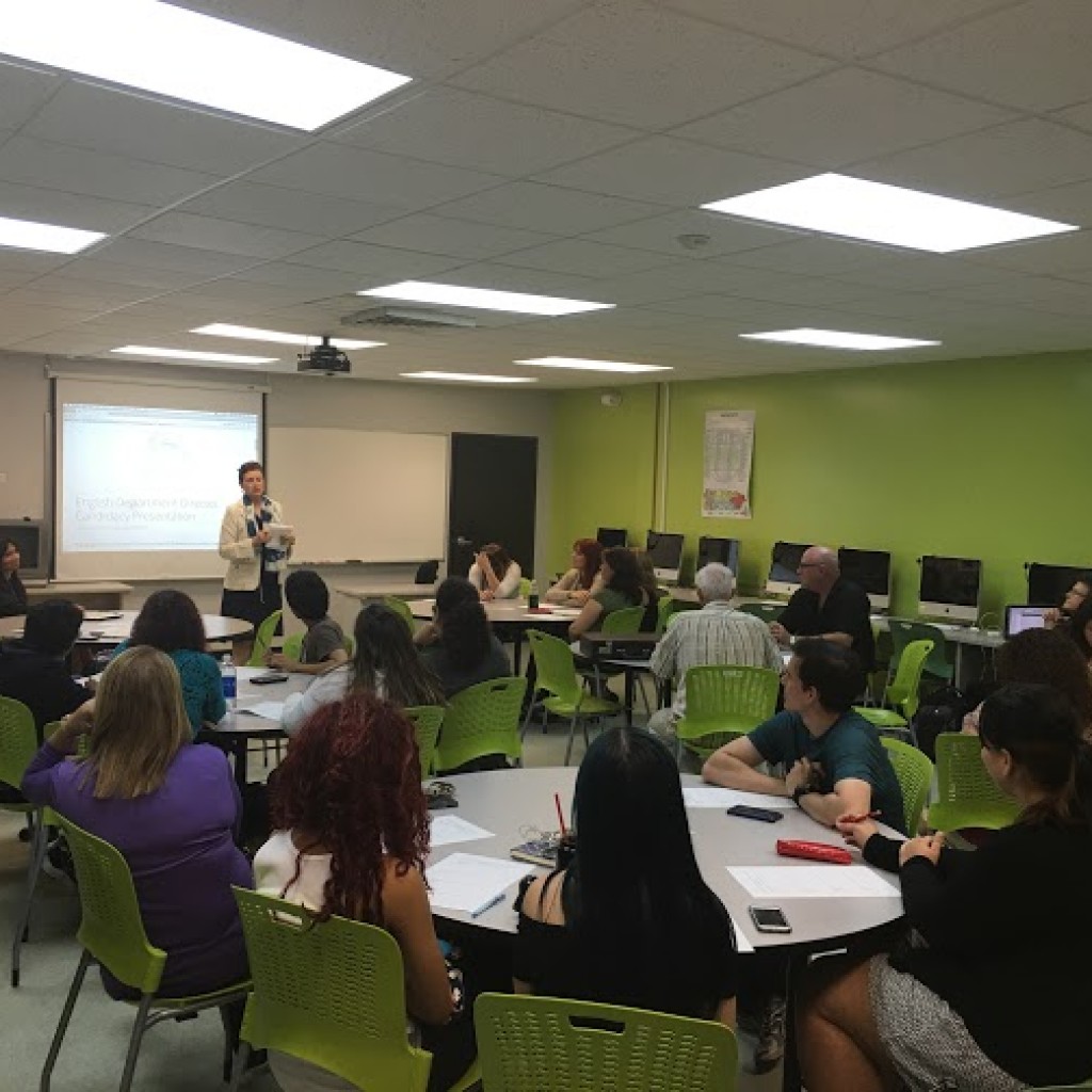 Dr. Rosita Rivera's Candicacy presentation. The room has several professors present and one of the members of the committee is presenting the speaker.