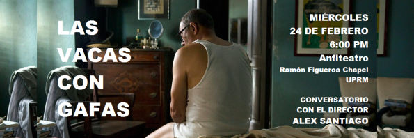 A man is sitting on a bed, looking to the side.