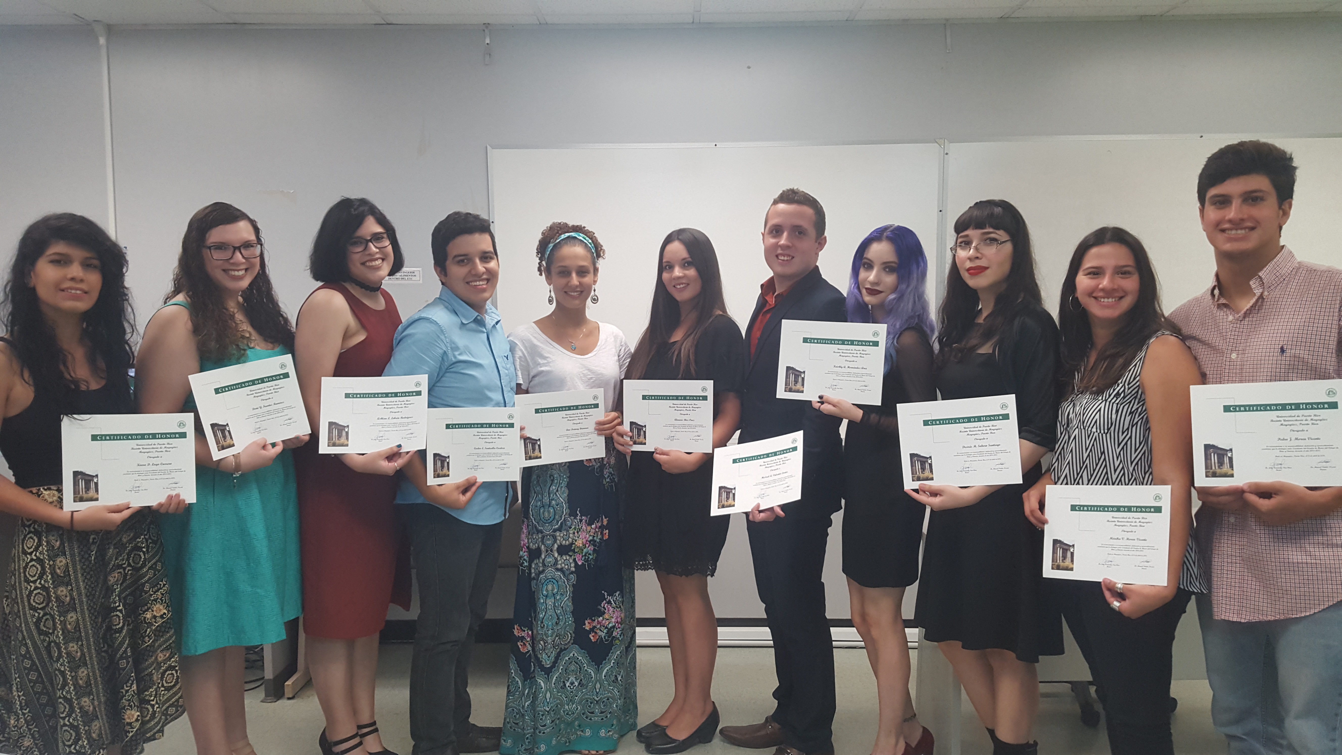 The Honor Roll Students posing for the camera while holding up their certificates.