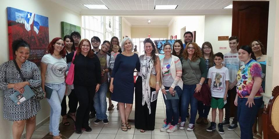 unnamed (1) Students, members and faculty posing for the camera in a hallway.