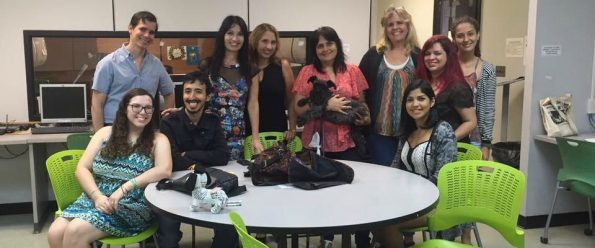 Faculty members and students all posing for the camera. This picture is closer still so you can see Dr. Betsy Morales holding up her dog.