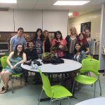 Faculty members and students all posing for the camera.