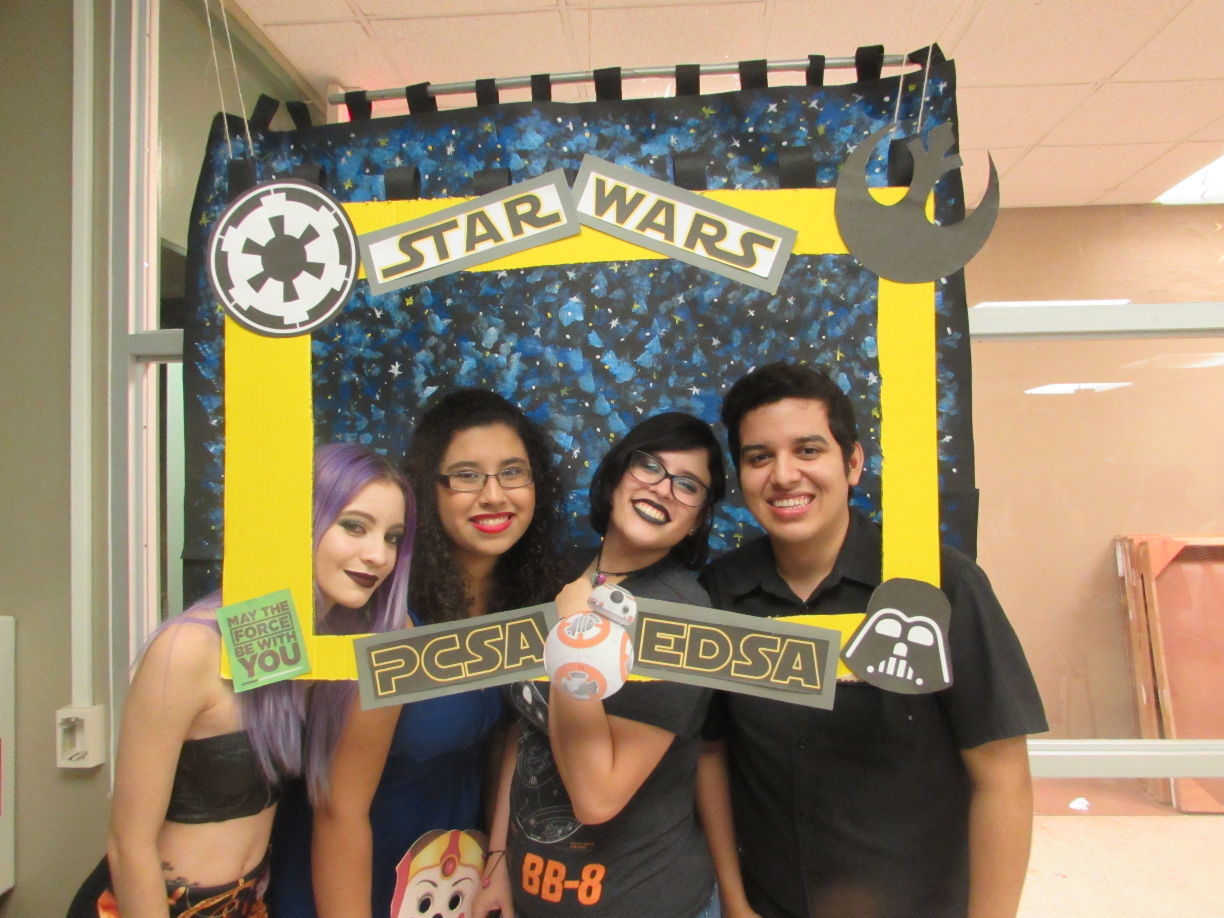 Attendants of the joint activity of May the 4th Be with you by EDSA & PCSA posing for the camera while holding up a promotional frame for PCSA and EDSA.