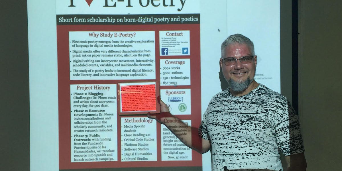 leo2 Dr. Leonardo Flores focusing the attention of the audience at a specific part of an image of a website being displayed at the projector. Particularly the idea of having a live poster where he placed an iPad among the text and a digital work would display.