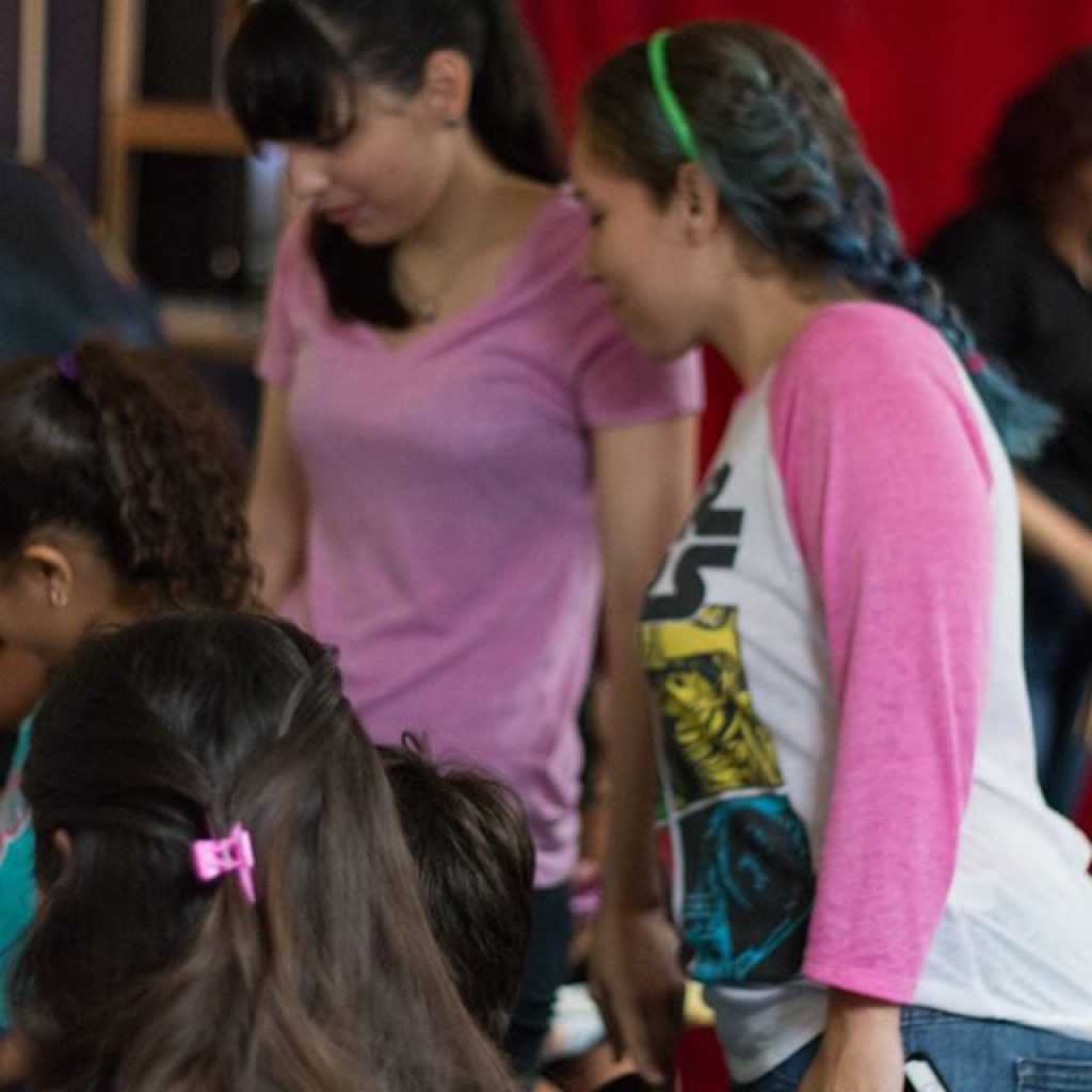 EDSA members looking at children and other members working on the crafts.