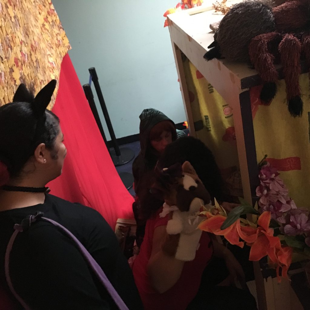 A member in costume is interacting with the children at the Children's Library Puppet Show.