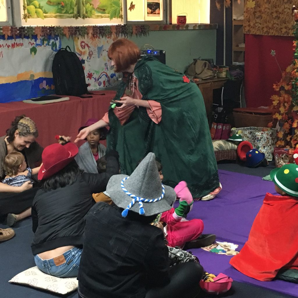 A member in costume is interacting with the children at the Children's Library Puppet Show.