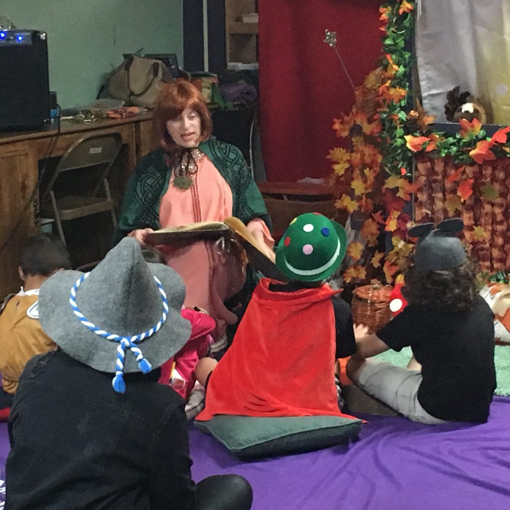 A member in costume is interacting with the children at the Children's Library Puppet Show.