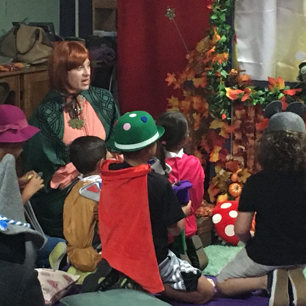 A member in costume is interacting with the children at the Children's Library Puppet Show.
