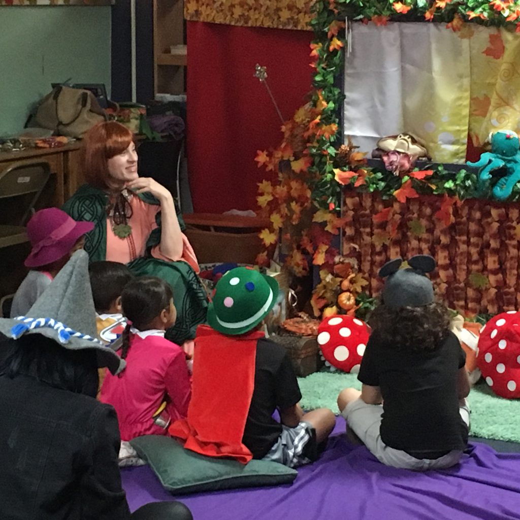 A member in costume is interacting with the children at the Children's Library Puppet Show.