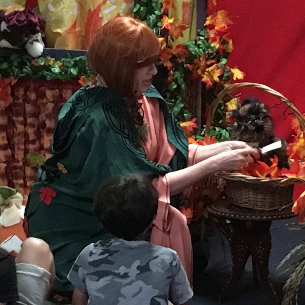 A member in costume is interacting with the children at the Children's Library Puppet Show.