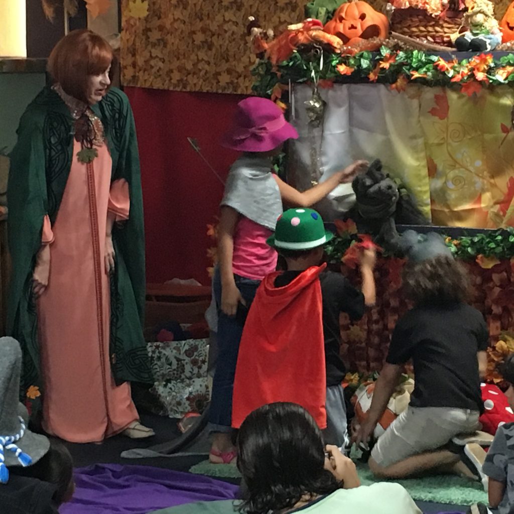 Children interacting with the puppets at the puppet show.