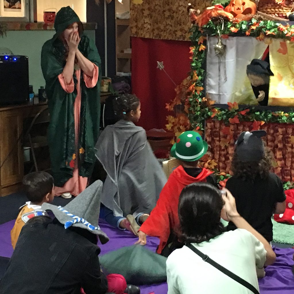 Children interacting with the puppets at the puppet show.