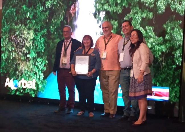 La profesora Mildred Cortés fue Presidenta de la entidad en el 2000, año que Puerto Rico tuvo la sede de la conferencia. Desde ese entonces, ejerce como la tesorera de la organización. Suministrada ACORBAT