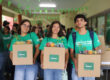 Tres estudiantes del campamento Agriculture Week Challenge de pie sostienen sus cajas Agrobox con experimentos relacionados a la agricultura.