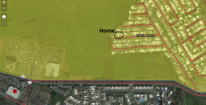 Satellite image of Mansion del Mar community and the surrounding area, overlayed with the yellow evacuation zone. The evacuation routes lead to an assembly point on the lower left of the image.