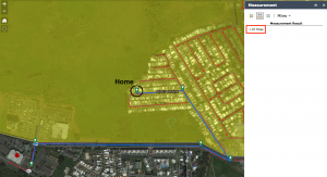 Satellite image of Mansion del Mar community and the surrounding area, with the overlay of the yellow evacuation zone, red evacuation routes, and assembly point on the interactive Map Tool. It is a screenshot of using the distance measurement tool and shows a blue line drawn from the starting point following the evacuation route to the assembly point. The distance measured is 1.07 miles.